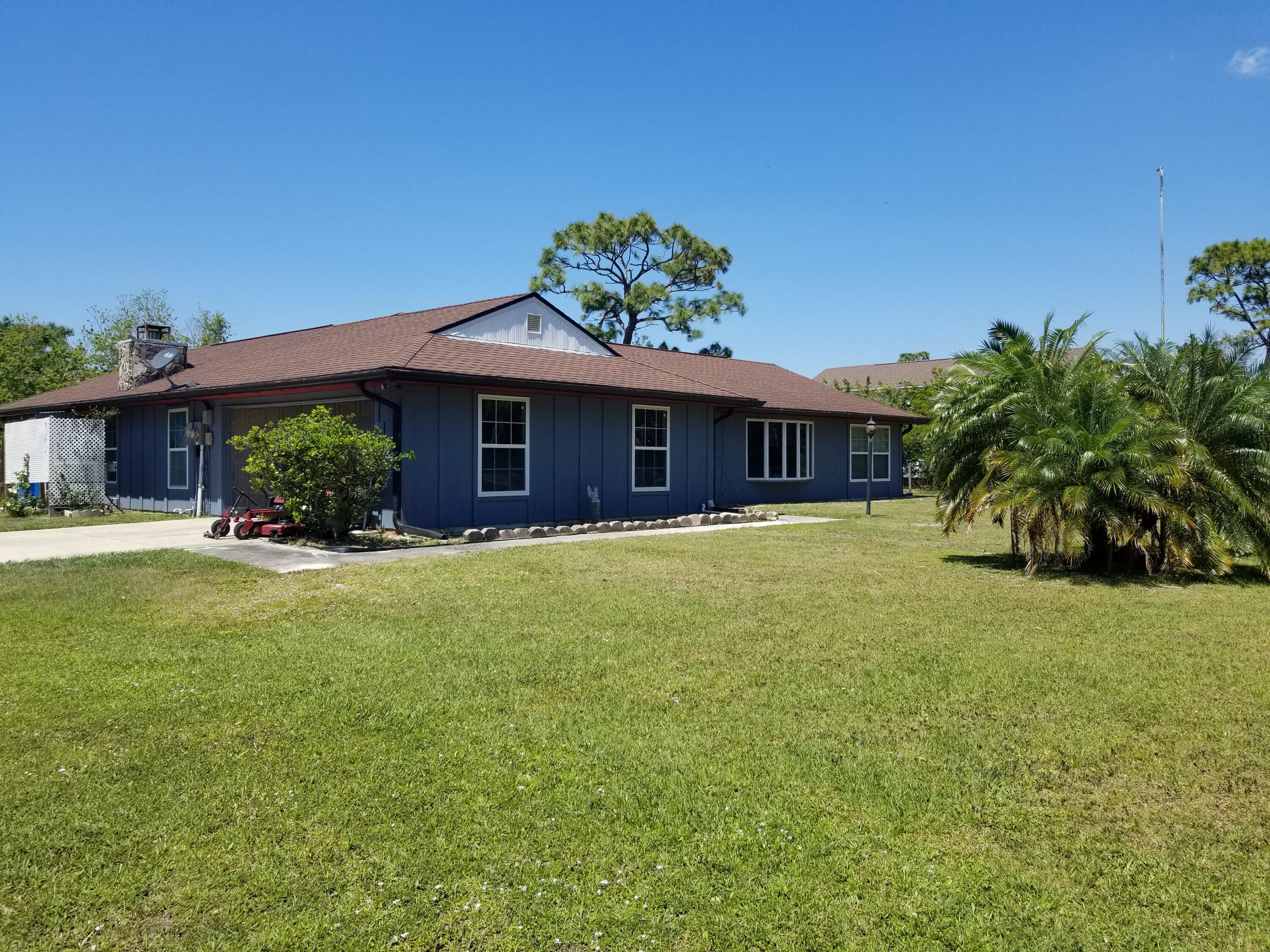 3700 Pine Cone Road Melbourne, FL 32934 - Photo 4 of 38 a front view of a house with a yard