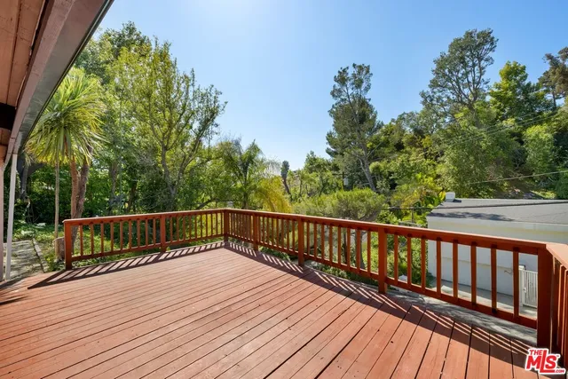 a view of balcony with wooden floor and fence