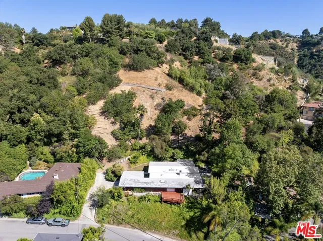 an aerial view of a house with a yard