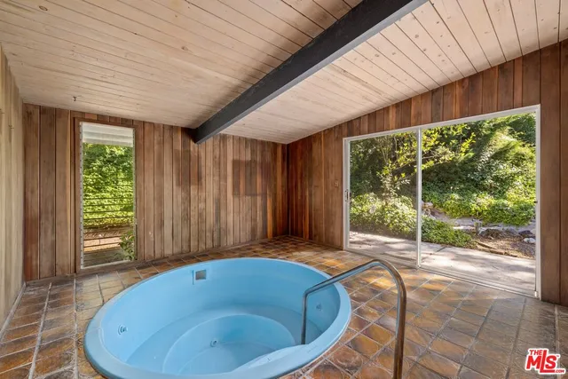 a view of a tub and chairs in a patio