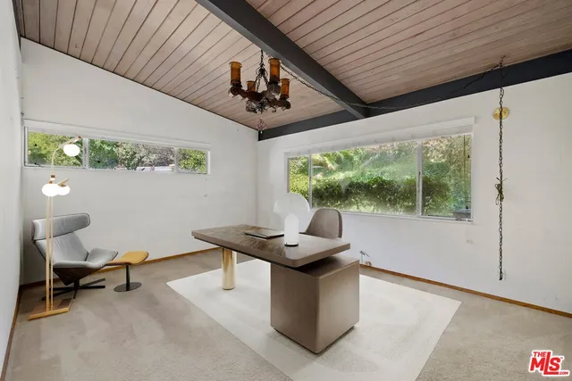 a work room with furniture and a window