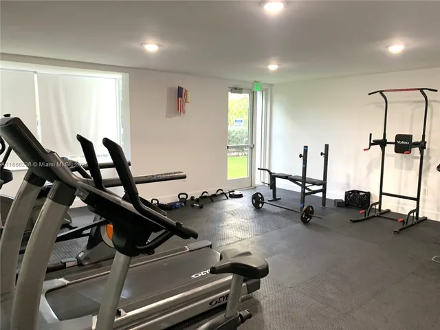 a room with gym equipment and a large window