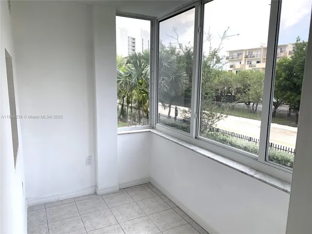 a view of empty room with large windows