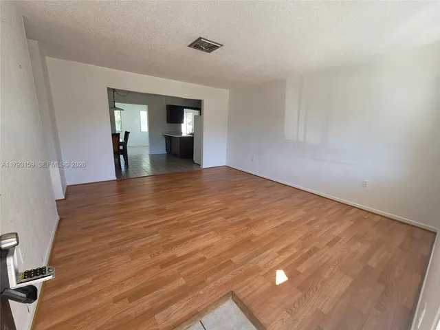 a view of a room with wooden floor and staircase