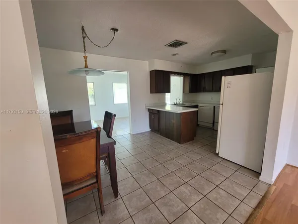 a workspace with furniture and a refrigerator