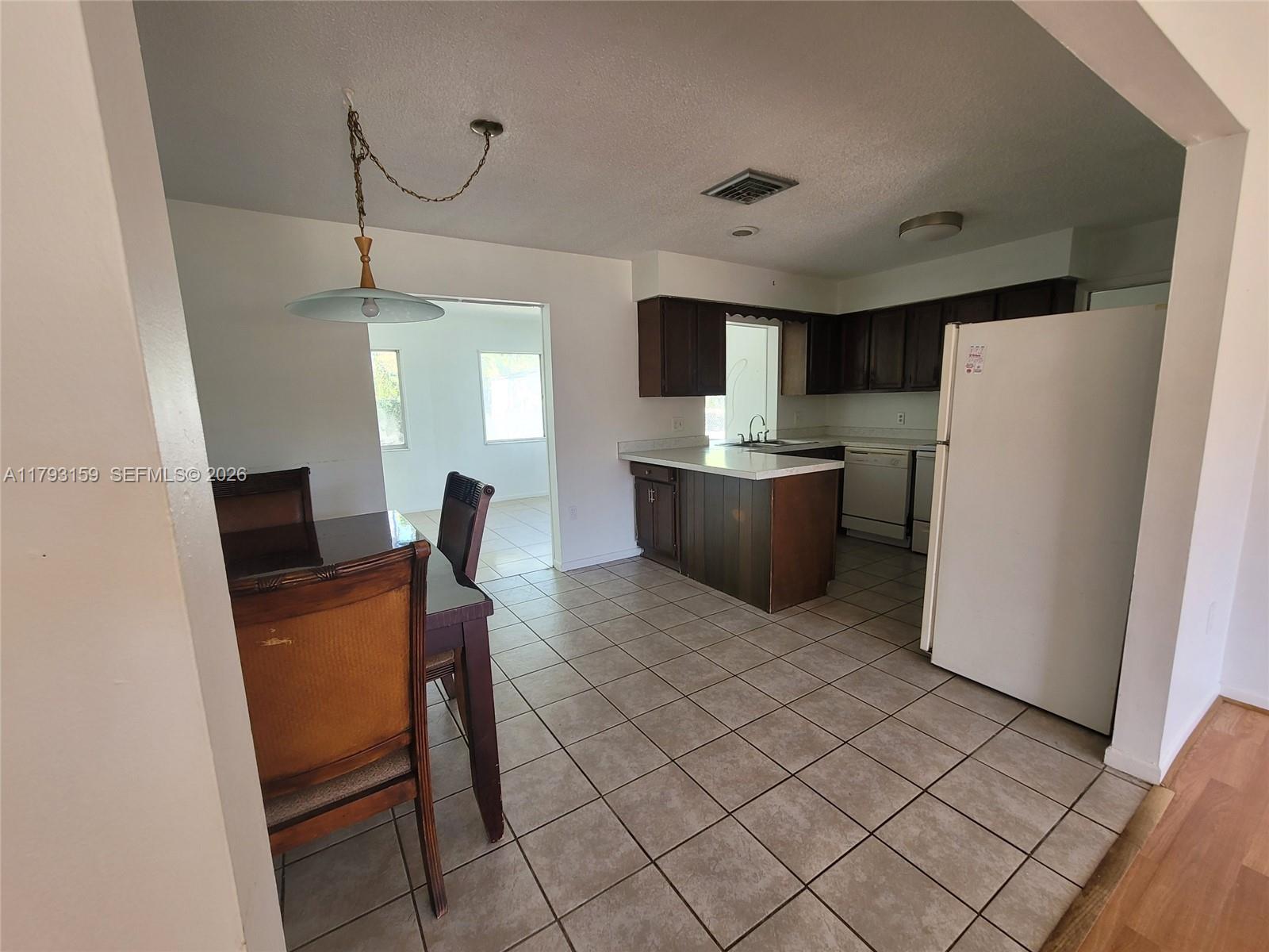 1112 Evanston Street Sebring, FL 33870 - Photo 15 of 41 a workspace with furniture and a refrigerator