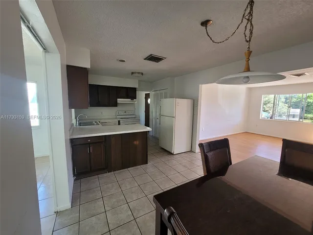 a kitchen with stainless steel appliances a refrigerator and a stove top oven