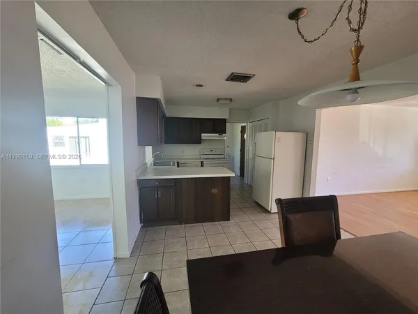 a kitchen with stainless steel appliances a refrigerator and a stove top oven