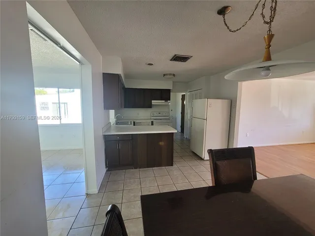 a kitchen with stainless steel appliances a refrigerator and a stove top oven