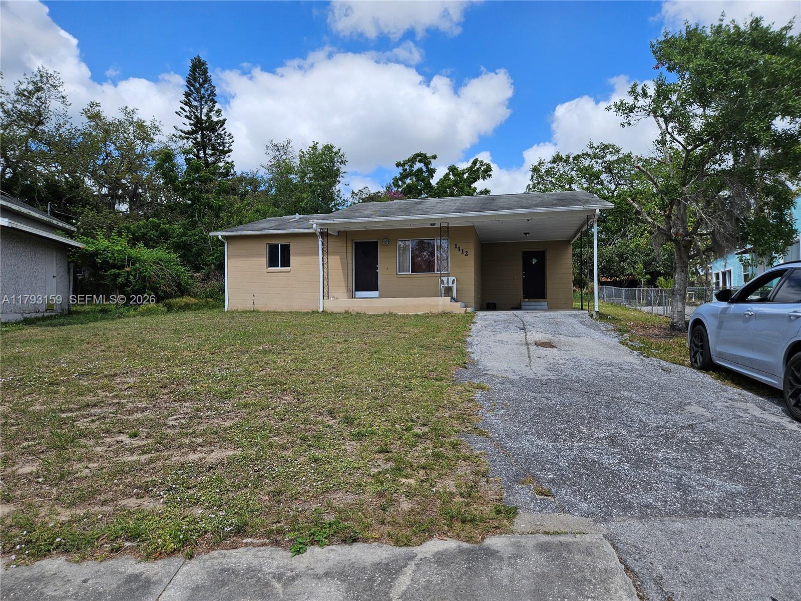 1112 Evanston Street Sebring, FL 33870 - Photo 2 of 41 a view of a house with a yard
