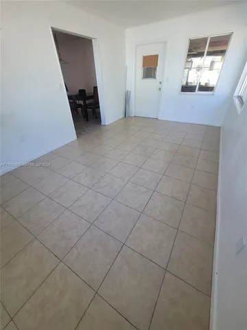 a view of a livingroom with an empty space and a window