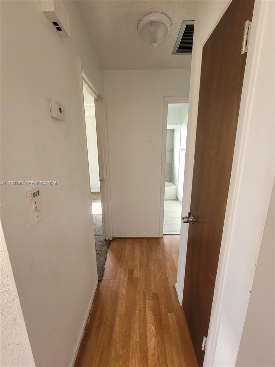 1112 Evanston Street Sebring, FL 33870 - Photo 26 of 41 a view of empty room with wooden floor
