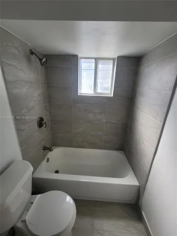 a bathroom with a toilet and bathtub