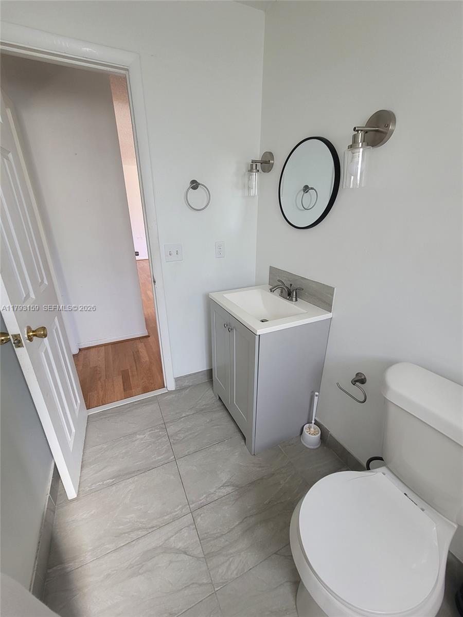 1112 Evanston Street Sebring, FL 33870 - Photo 29 of 41 a bathroom with a toilet sink and mirror