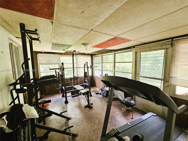 a room with gym equipment and a large window