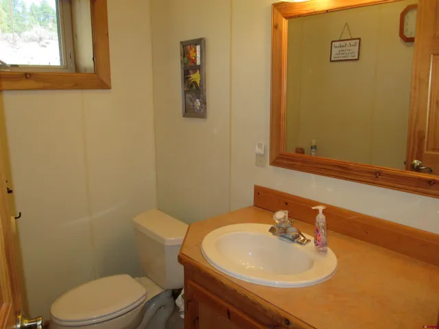 a en suite bathroom with a granite countertop shower a sink and a mirror