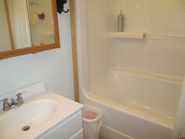 a bedroom with a bed and a table