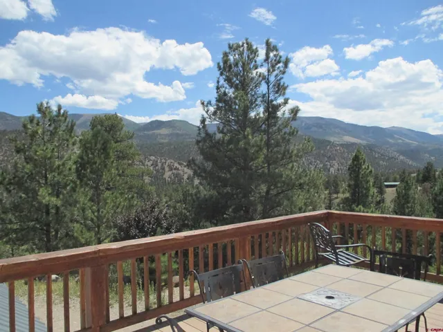 a view of a city with lush green forest