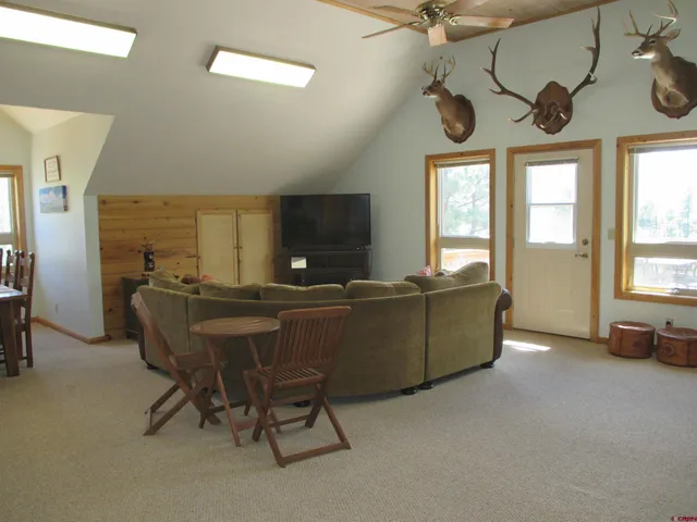 a bedroom with furniture and a wooden floor