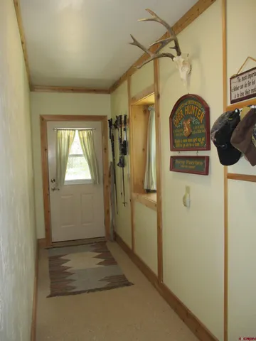 a bedroom with a bed and a lamp on dresser