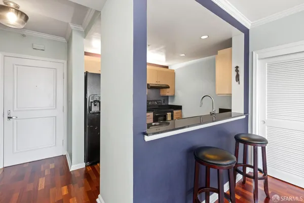 a kitchen with stainless steel appliances kitchen island granite countertop a refrigerator and a sink