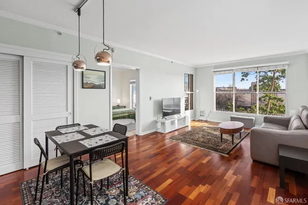 a living room with furniture a wooden floor and a window