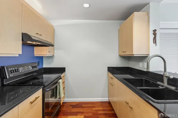 a kitchen that has a sink and a stove