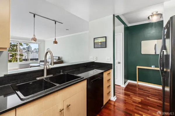 a kitchen with granite countertop a sink stove and cabinets