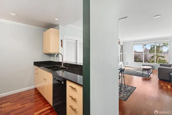a kitchen with granite countertop a stove and a sink