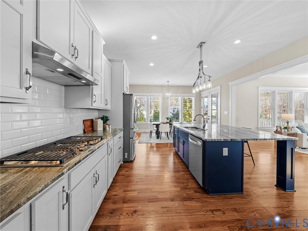 2001 Tulip Hill Drive Midlothian, VA 23112 - Photo 12 of 50 a large kitchen with stainless steel appliances granite countertop a stove and a wooden floors