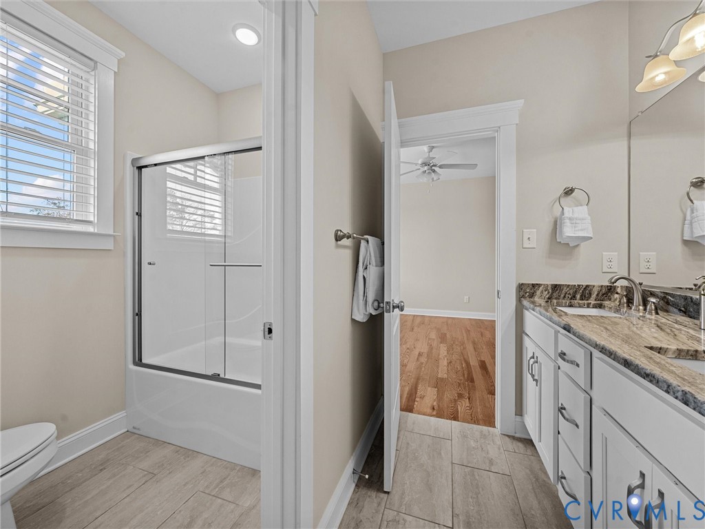 2001 Tulip Hill Drive Midlothian, VA 23112 - Photo 38 of 50 a bathroom with a granite countertop sink a toilet and shower