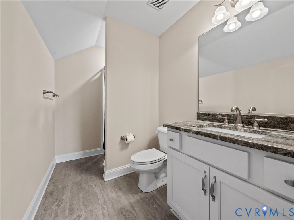 2001 Tulip Hill Drive Midlothian, VA 23112 - Photo 45 of 50 a bathroom with a granite countertop sink a toilet and a mirror