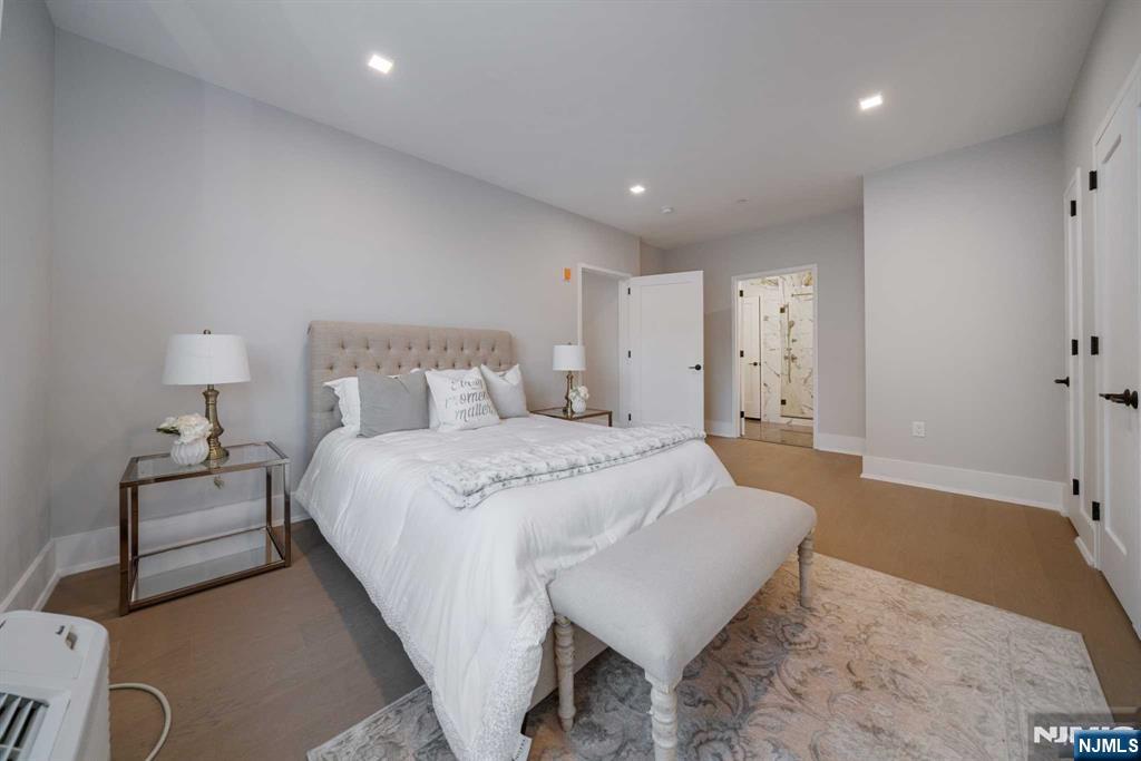 7101 River Road, Unit 304A North Bergen, NJ 07047 - Photo 15 of 24 a spacious bedroom with a bed and a lamp