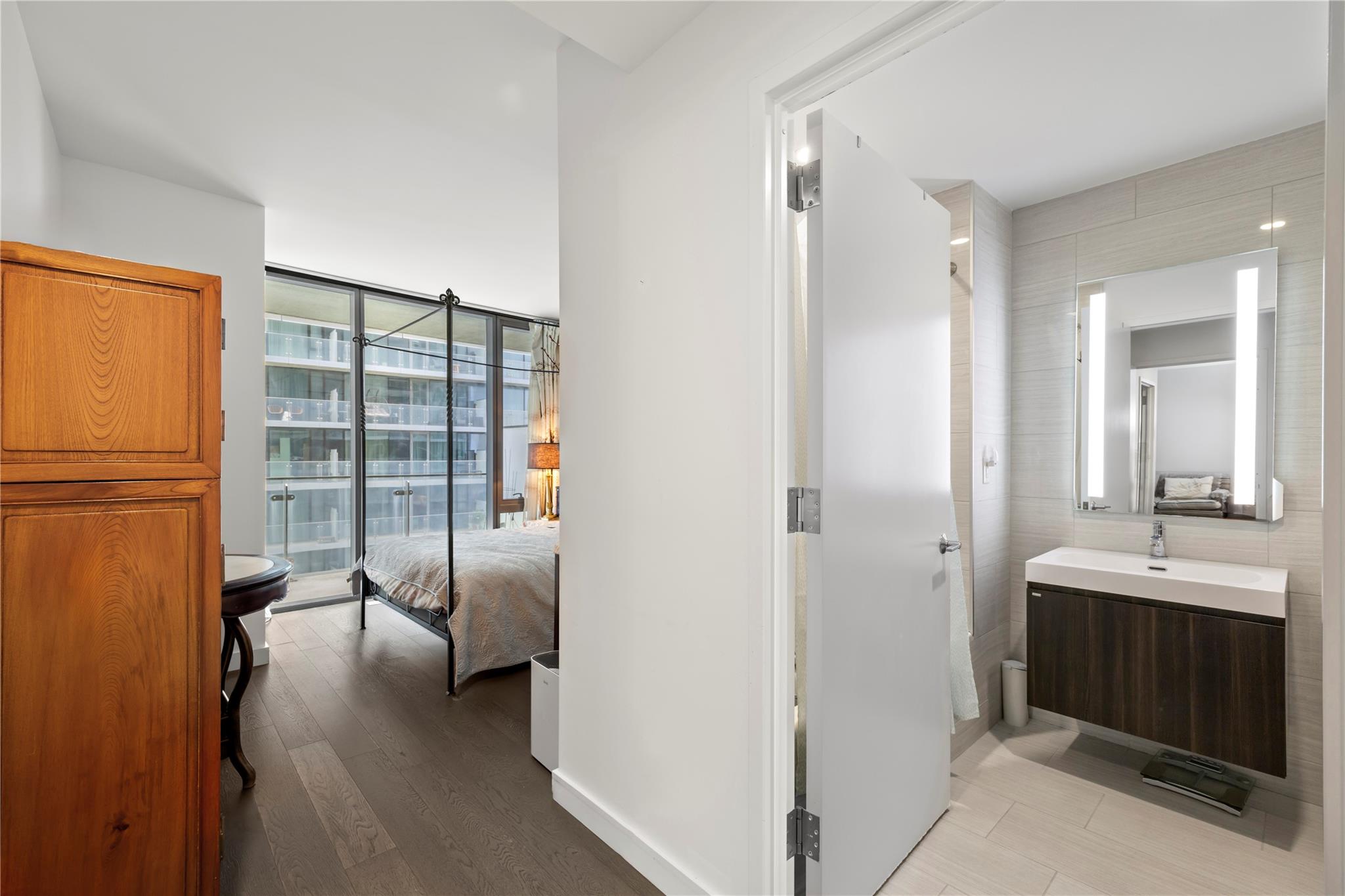 131-05 40 Road, Unit 11M Queens, NY 11354 - Photo 20 of 24 Bathroom with wood finished floors, vanity, and a wall of windows