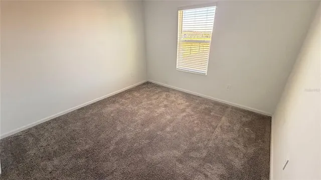 an empty room with an entrance to other room