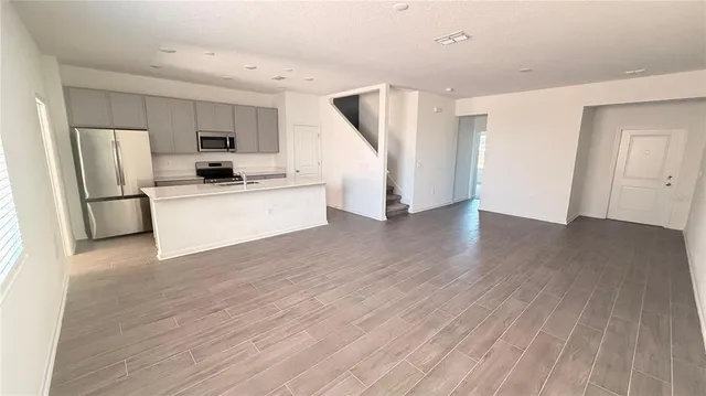 a kitchen with stainless steel appliances a refrigerator and a stove top oven
