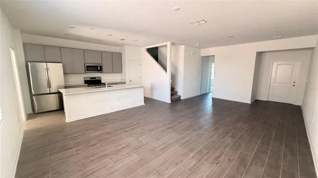 a kitchen with stainless steel appliances a refrigerator and a stove top oven