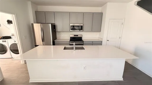 a white refrigerator freezer sitting inside of a kitchen