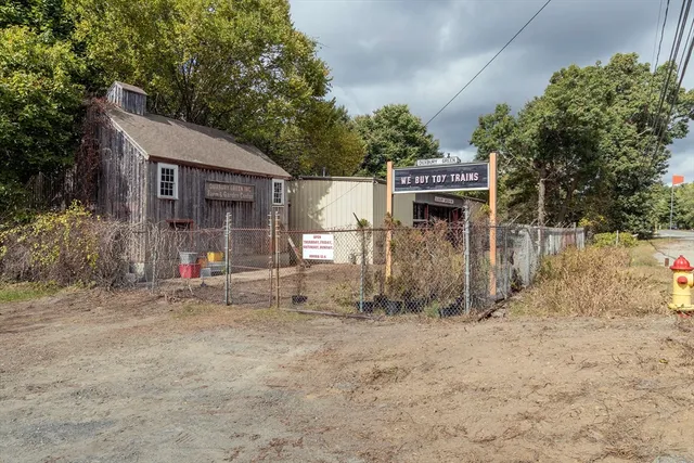 a view of a house with a yard and fence