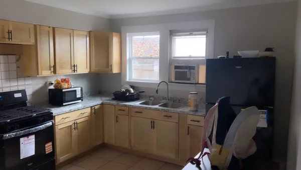 a kitchen with a sink stove and cabinets