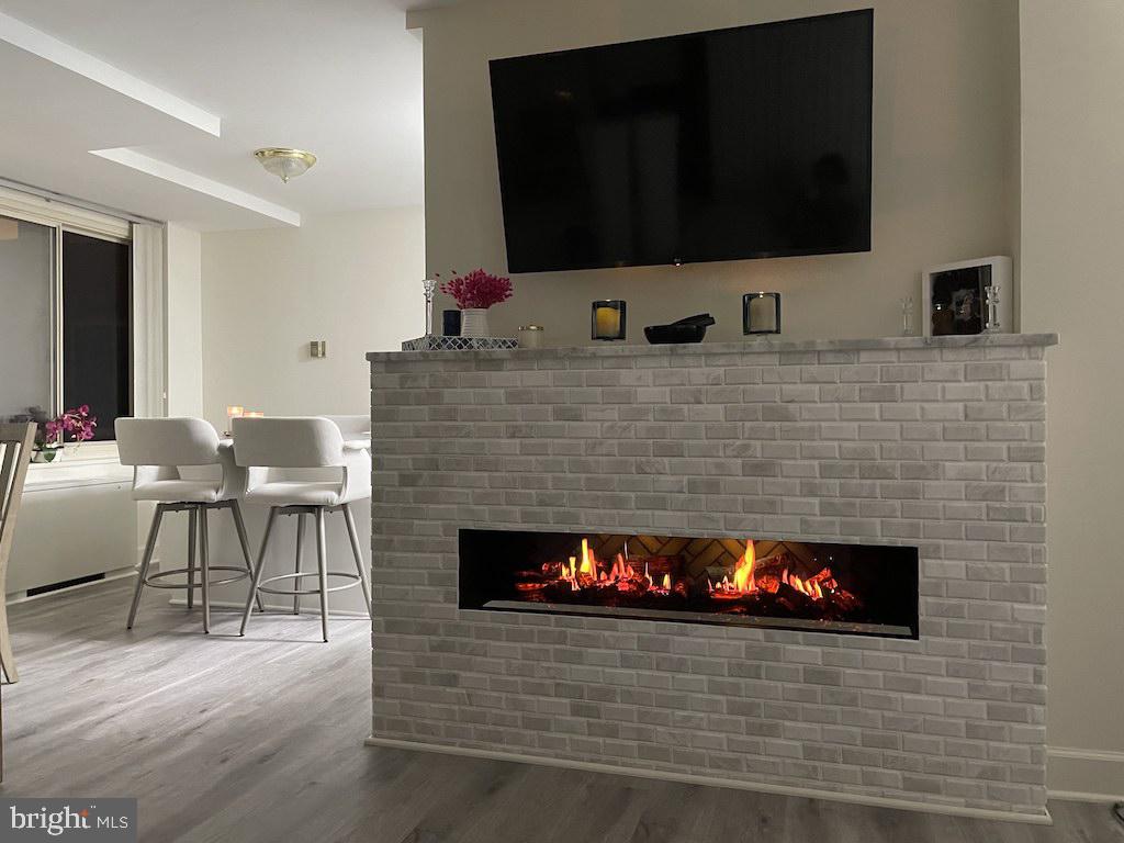 4000 Tunlaw Road Northwest, Unit 516 Washington, DC 20007 - Photo 1 of 35 a living room with furniture and a fireplace