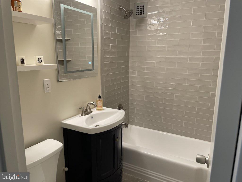 4000 Tunlaw Road Northwest, Unit 516 Washington, DC 20007 - Photo 12 of 35 a bathroom with a sink a toilet and shower