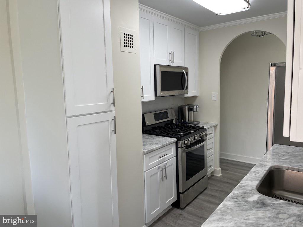 4000 Tunlaw Road Northwest, Unit 516 Washington, DC 20007 - Photo 6 of 35 a kitchen with stainless steel appliances granite countertop a stove a microwave and a refrigerator