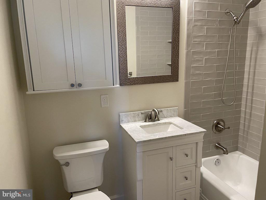 4000 Tunlaw Road Northwest, Unit 516 Washington, DC 20007 - Photo 8 of 35 a bathroom with a sink toilet and mirror