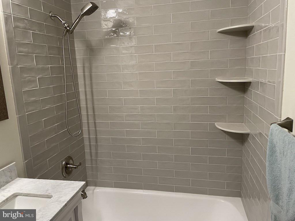 4000 Tunlaw Road Northwest, Unit 516 Washington, DC 20007 - Photo 9 of 35 a bathroom with a bathtub and shower