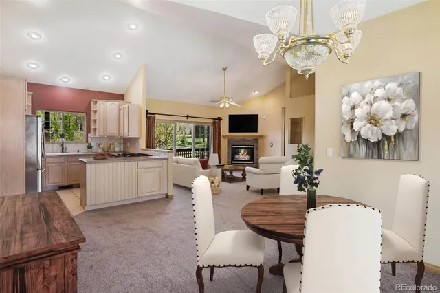 a living room with fireplace furniture and a chandelier