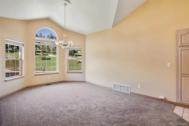 a view of a room with a large window and front door