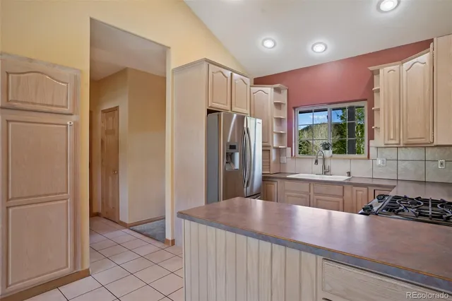 a kitchen with stainless steel appliances a refrigerator sink and microwave