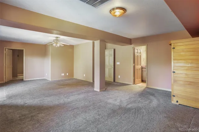 an empty room with windows and painted walls