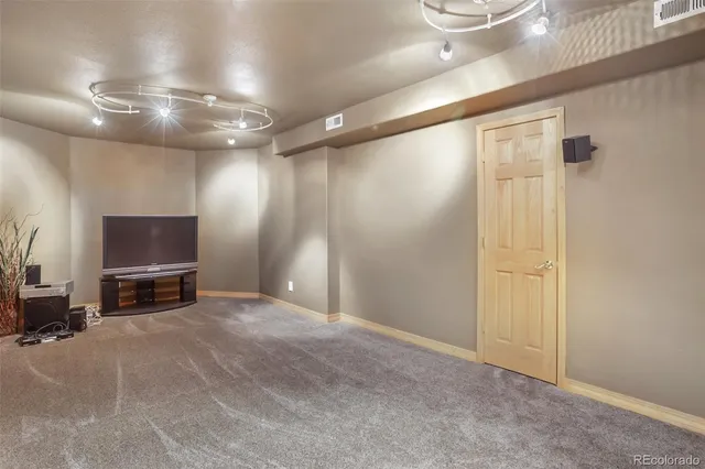 a view of a livingroom with furniture and a flat screen tv